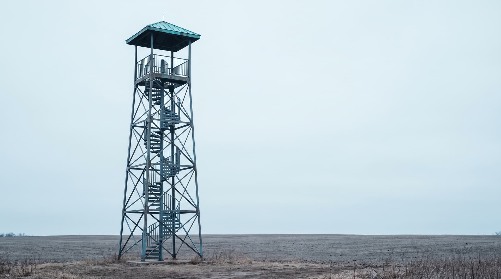 Slender steel observation tower with a spiral staircase and a verdigris copper platform roof above a wide plain – a metaphor for visibility in AI search systems